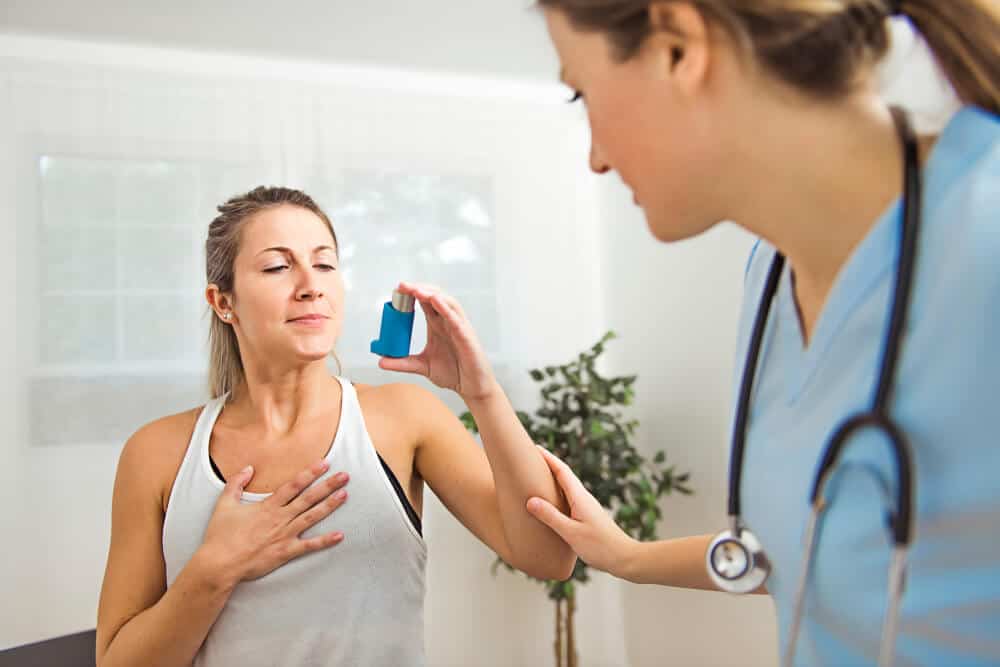 women holding asthma pump