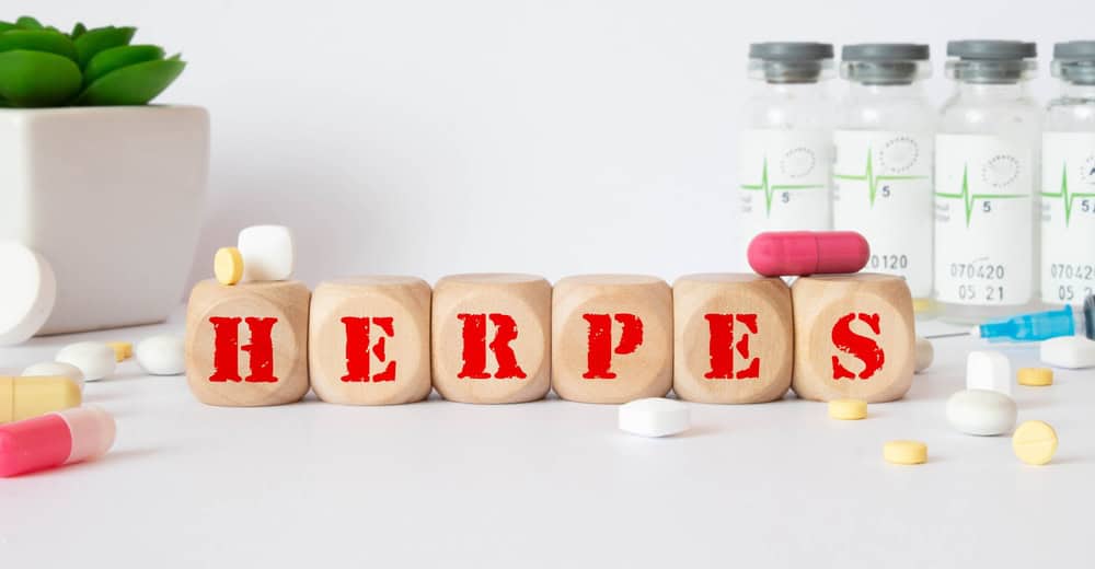 Herpes - word from wooden blocks with letters, viral diseases herpes viruses concept, blue background.